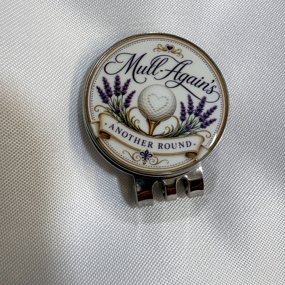 Mull-Again's logo ball marker seated on its hat clip