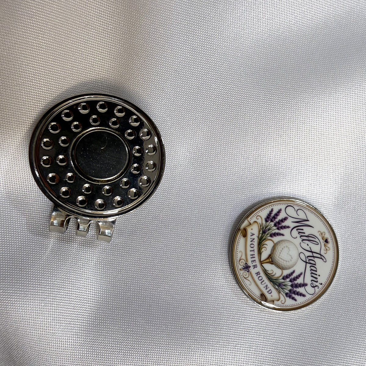 Hat clip with the ball marker popped off beside it