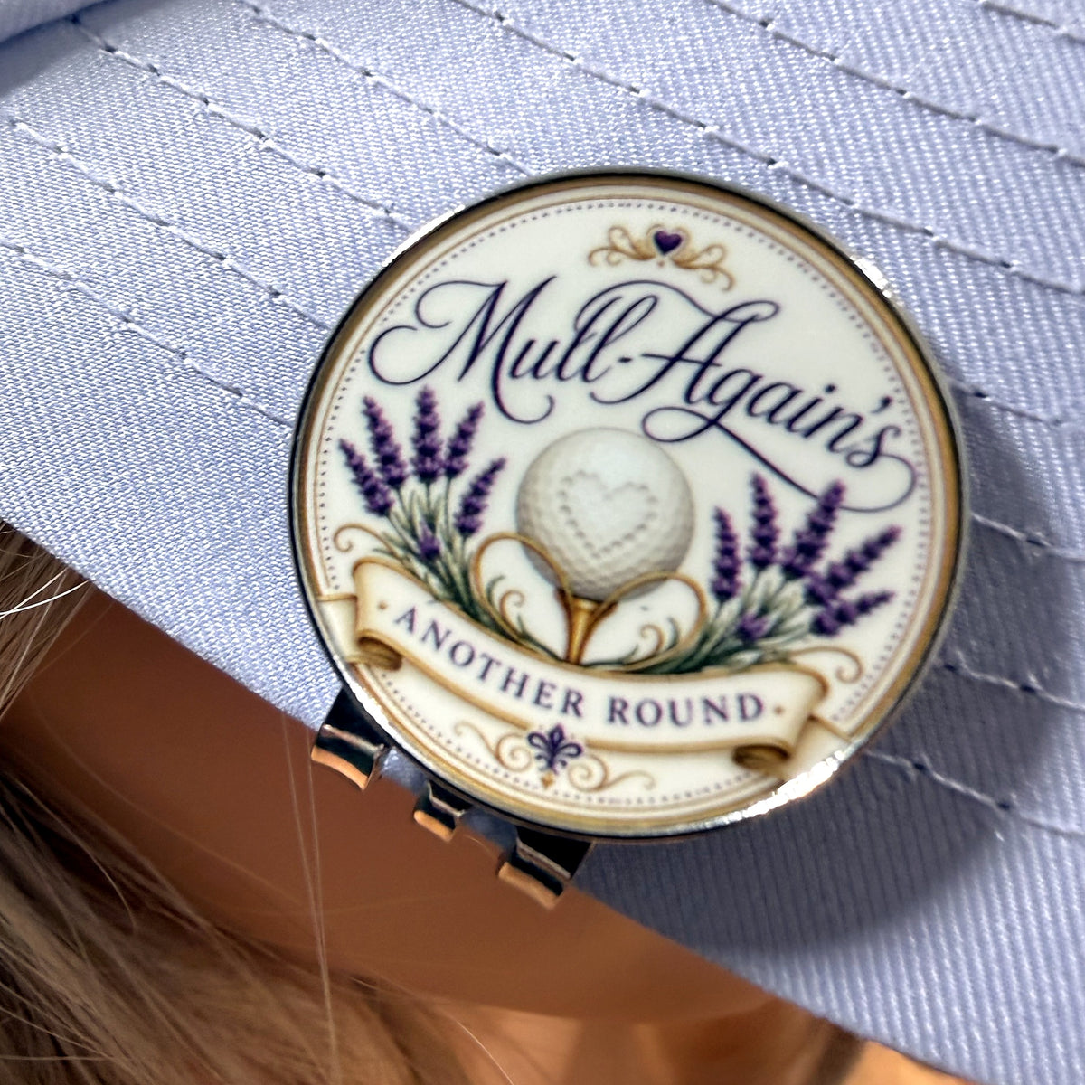 Mull-Again's logo ball marker clipped to a cap brim